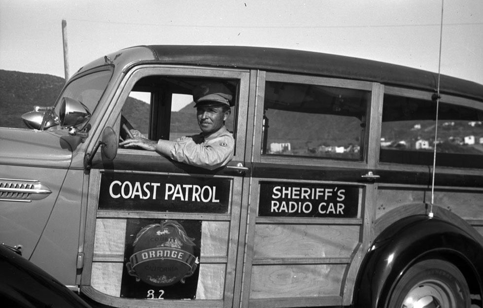 Dana Lamb in an Orange County Coast Patrol car, ca. 1938. Dana and Ginger Lamb Collection.