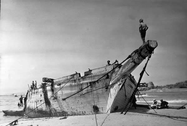 shipwreck washed ashore along the beach