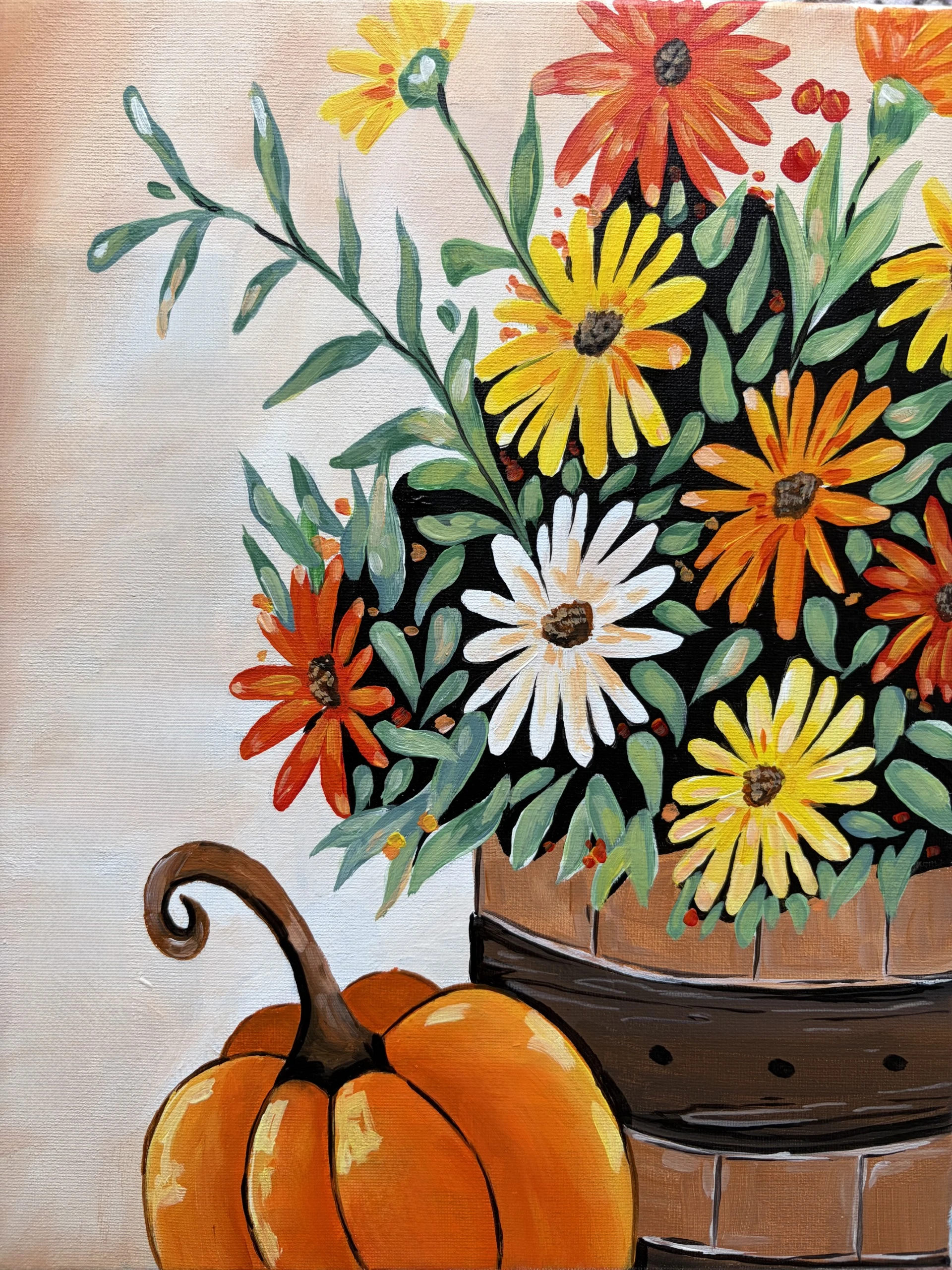 Harvest in Bloom: This beginner acrylic painting captures a wooden basket filled with yellow, orange, and white flowers, nestled among green leaves. A bright orange pumpkin rests in the lower left corner of the canvas, celebrating the beauty of a fall harvest.